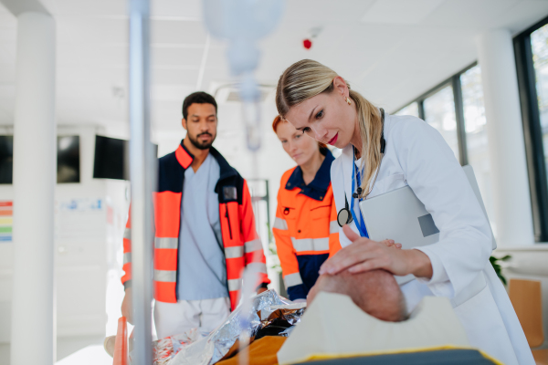 Young woman doctor taking care of patient from a rescue ambulance.