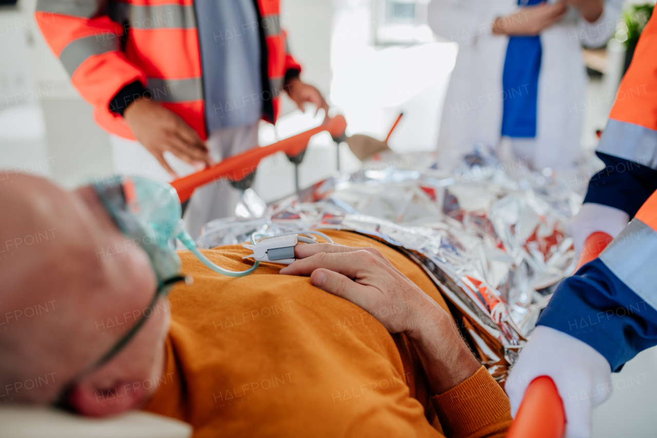 Rescuers taking care of patient from an ambulance.