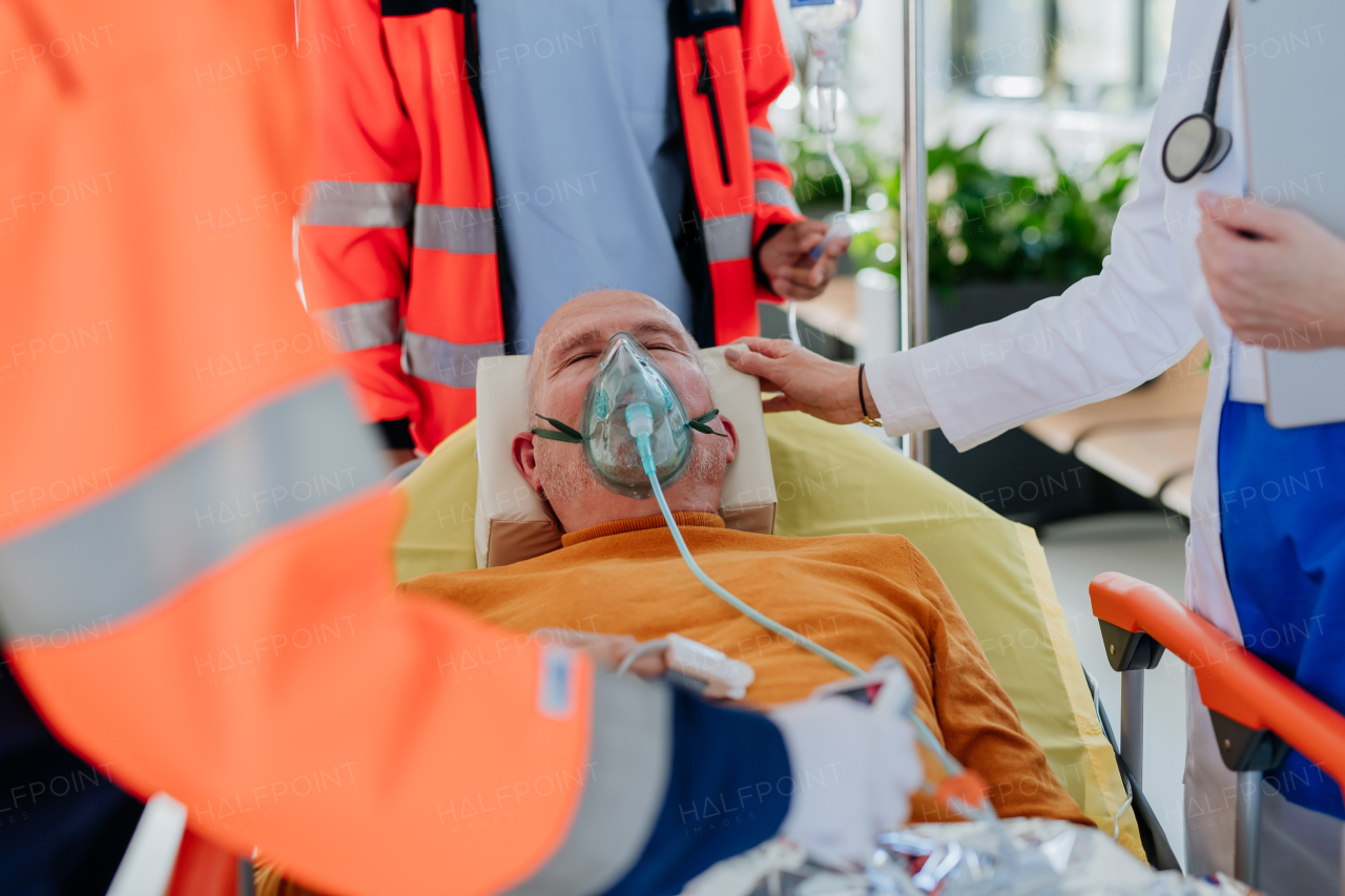 Rescuers taking care of patient from an ambulance.