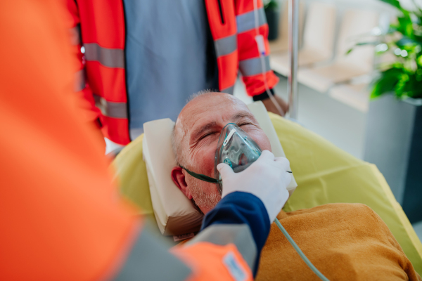 Rescuers taking care of patient from an ambulance, close-up.