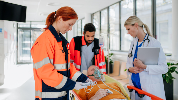 Young woman doctor taking care of patient from a rescue ambulance.