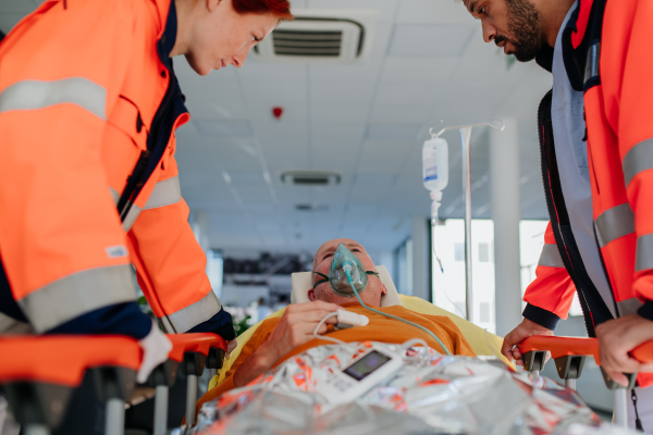 Rescuers taking care of patient from an ambulance.