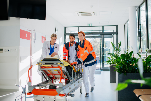 Young woman doctor taking care of patient from a rescue ambulance.