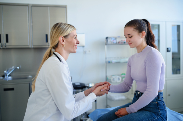 Young woman doctor examining teenage girl in the ambulance.