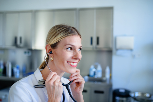 Portrait of smiling doctor in hospital office during examining patient.