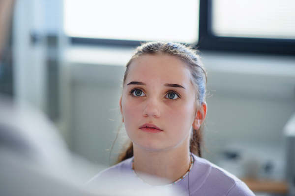 Portrait of disapointed girl in a doctors office.