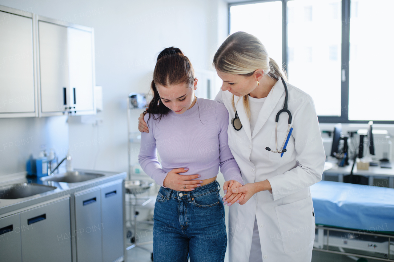 Close-up of doctor helping sick teenage girl in the ambulance office.