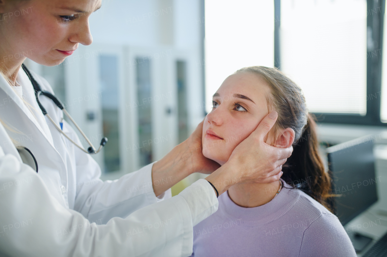 Young woman doctor examining teenage girl in the ambulance.