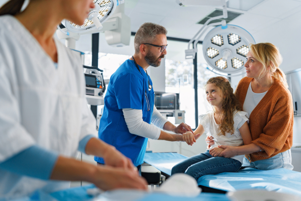 Little girl with mother in surgery examination.