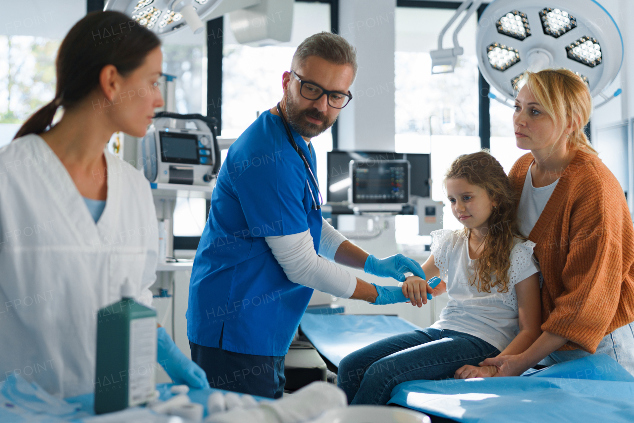 Little girl with mother in surgery examination.