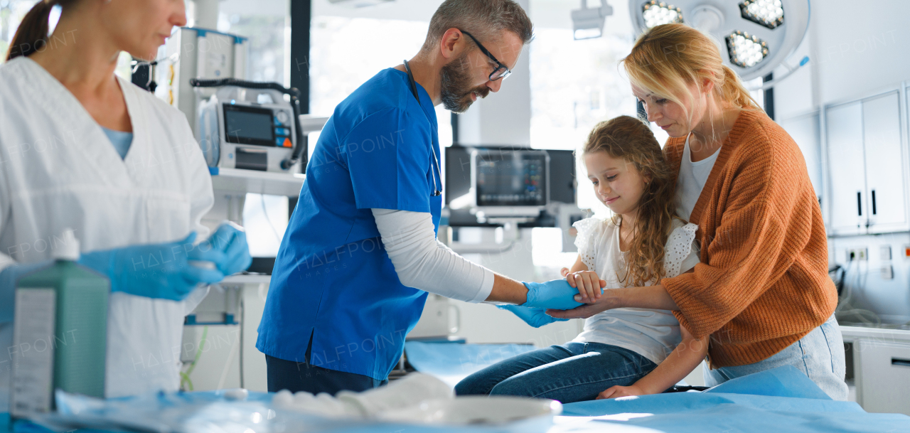 Little girl with mother in surgery examination.