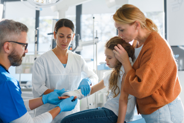 Little girl with mother in surgery examination.