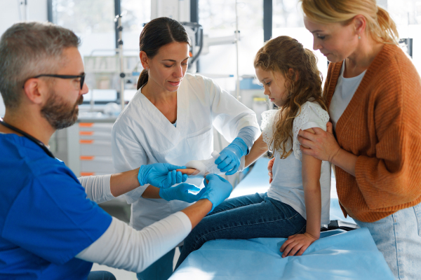 Little girl with mother in surgery examination.