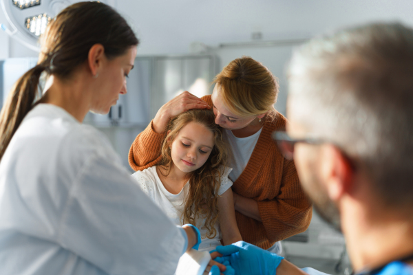 Little girl with mother in surgery examination.