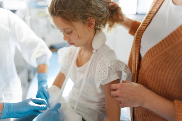 Little girl with mother in surgery examination.