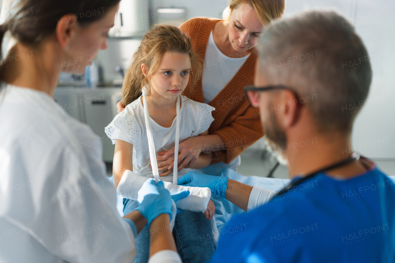 Little girl with mother in surgery examination.