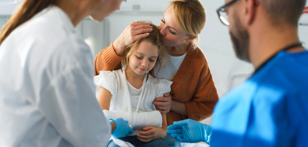 Little girl with mother in surgery examination.