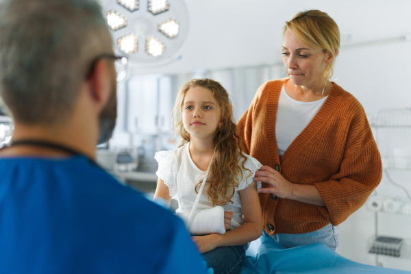 Little girl with mother in surgery examination.