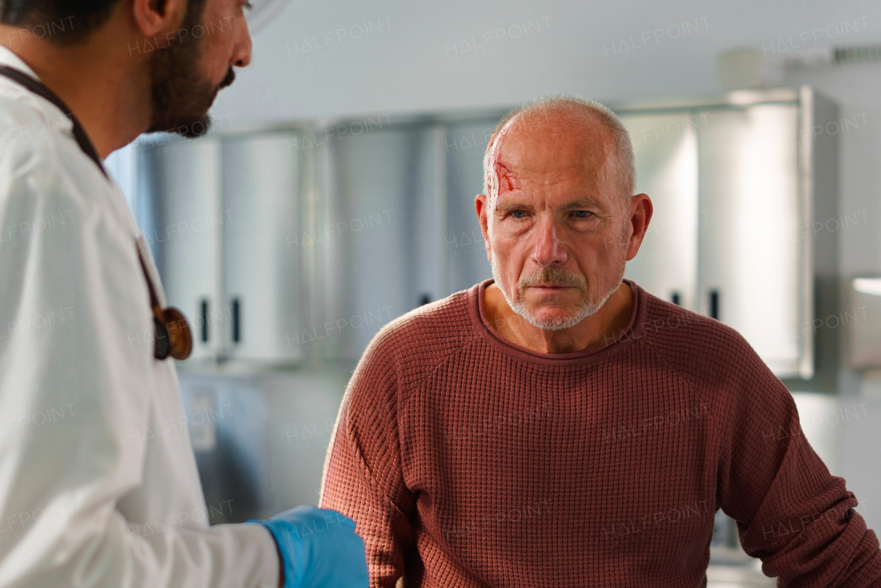 Senior man with injured head in a hospital.