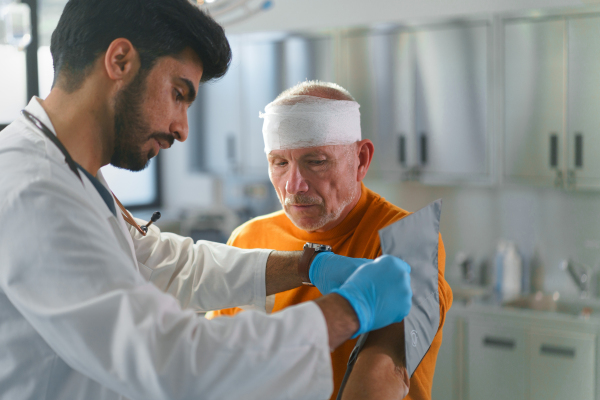 Senior man with injured head in a hospital.