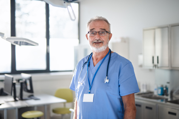 Portrait of elderly doctor in a hospital room.