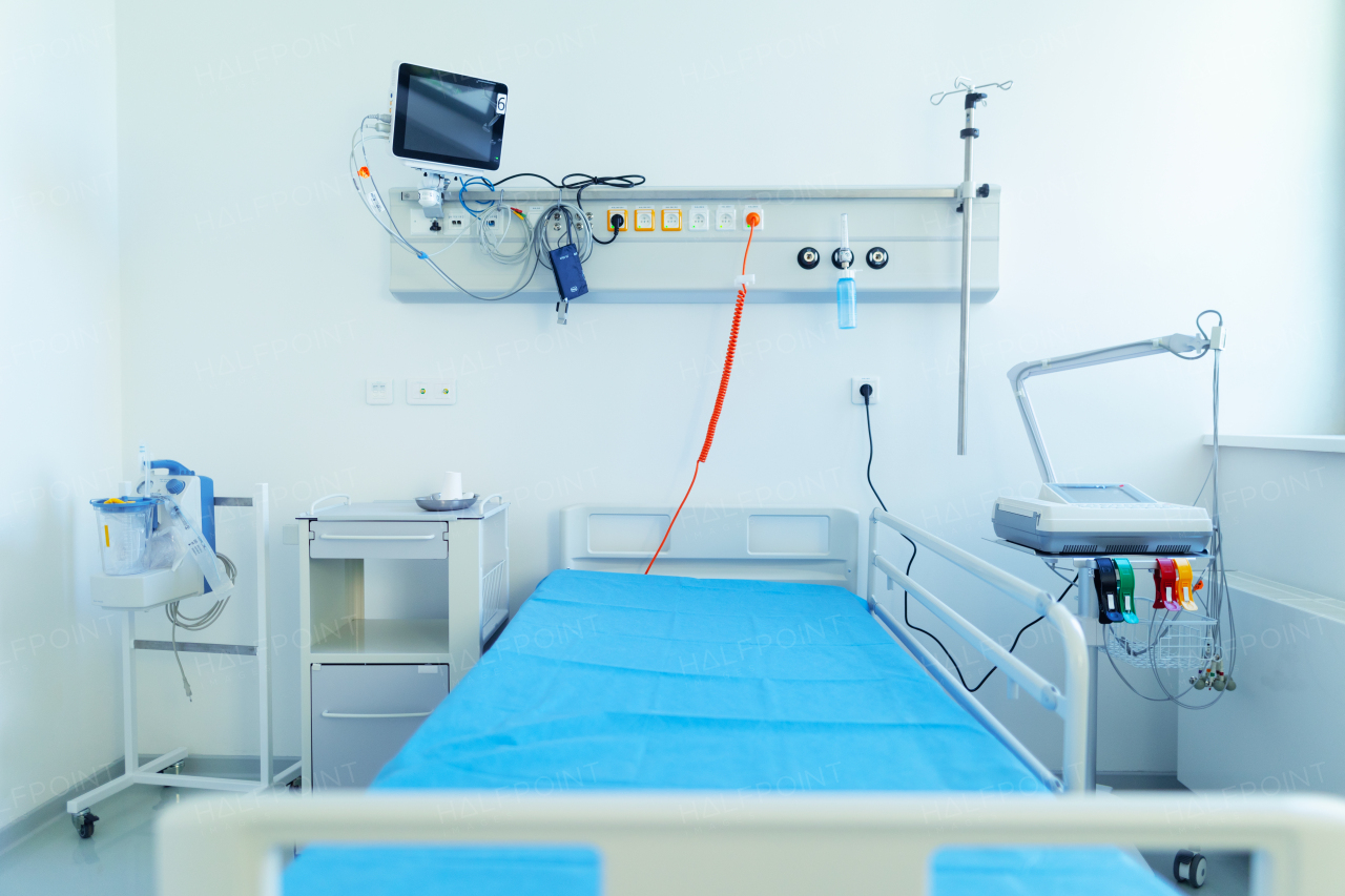 Close-up of empty hospital room with a bed.