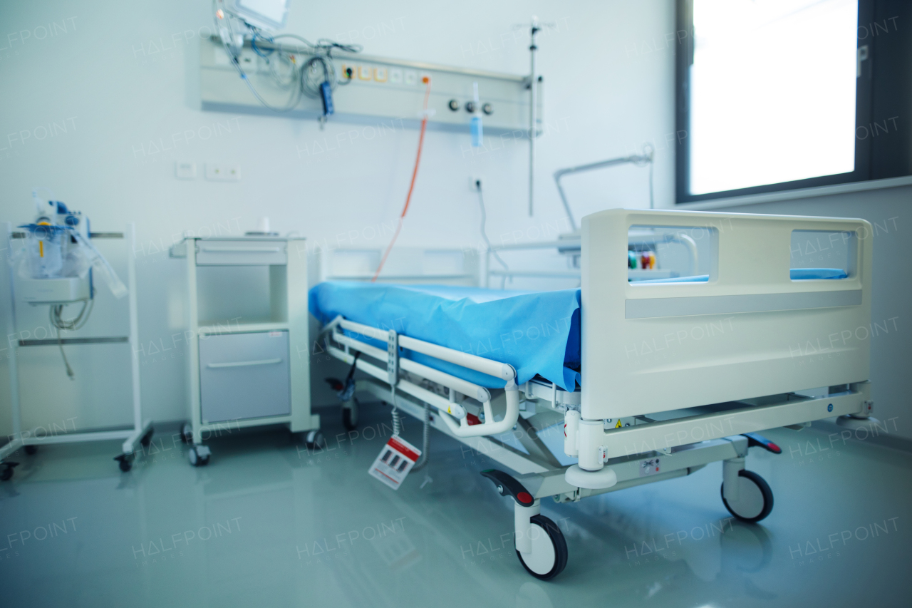 Close-up of empty hospital room with a bed.