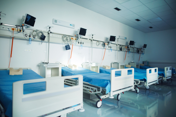 Close-up of empty hospital room with a bed.