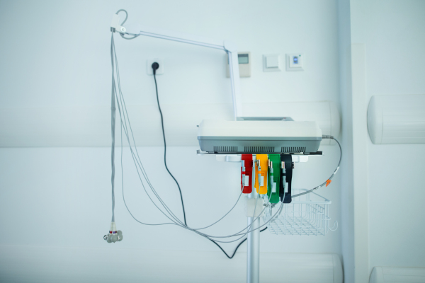 Close-up of EKG device in an empty hospital room.