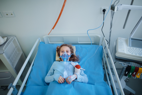 Close-up of girl with infection disease lying in hospital room.