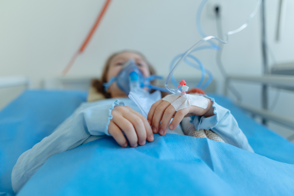 Close-up of girl with infection disease lying in hospital room.