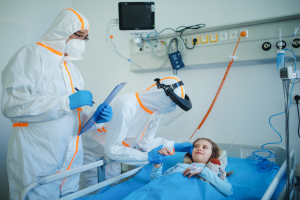 Close-up of girl with infection disease lying in hospital room.