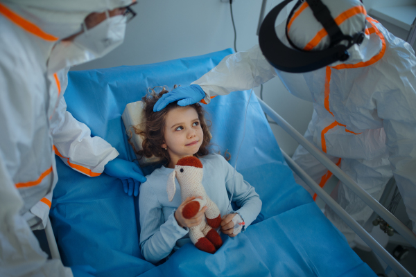 Close-up of girl with infection disease lying in hospital room.