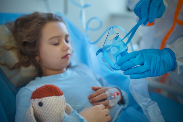 Close-up of girl with infection disease lying in hospital room.