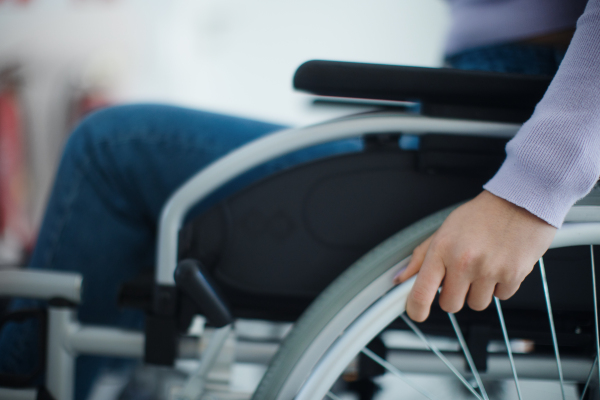 Close-up of young woman at wheelchair in a hospital.