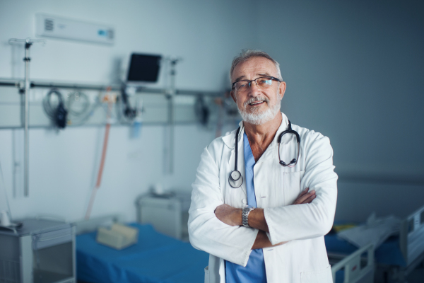 Portrait of elderly doctor at a hospital room.