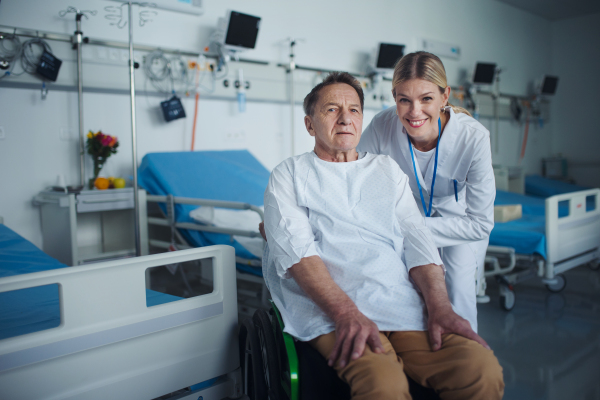 Portrait of happy doctor woman with her patient on a wheelchair.