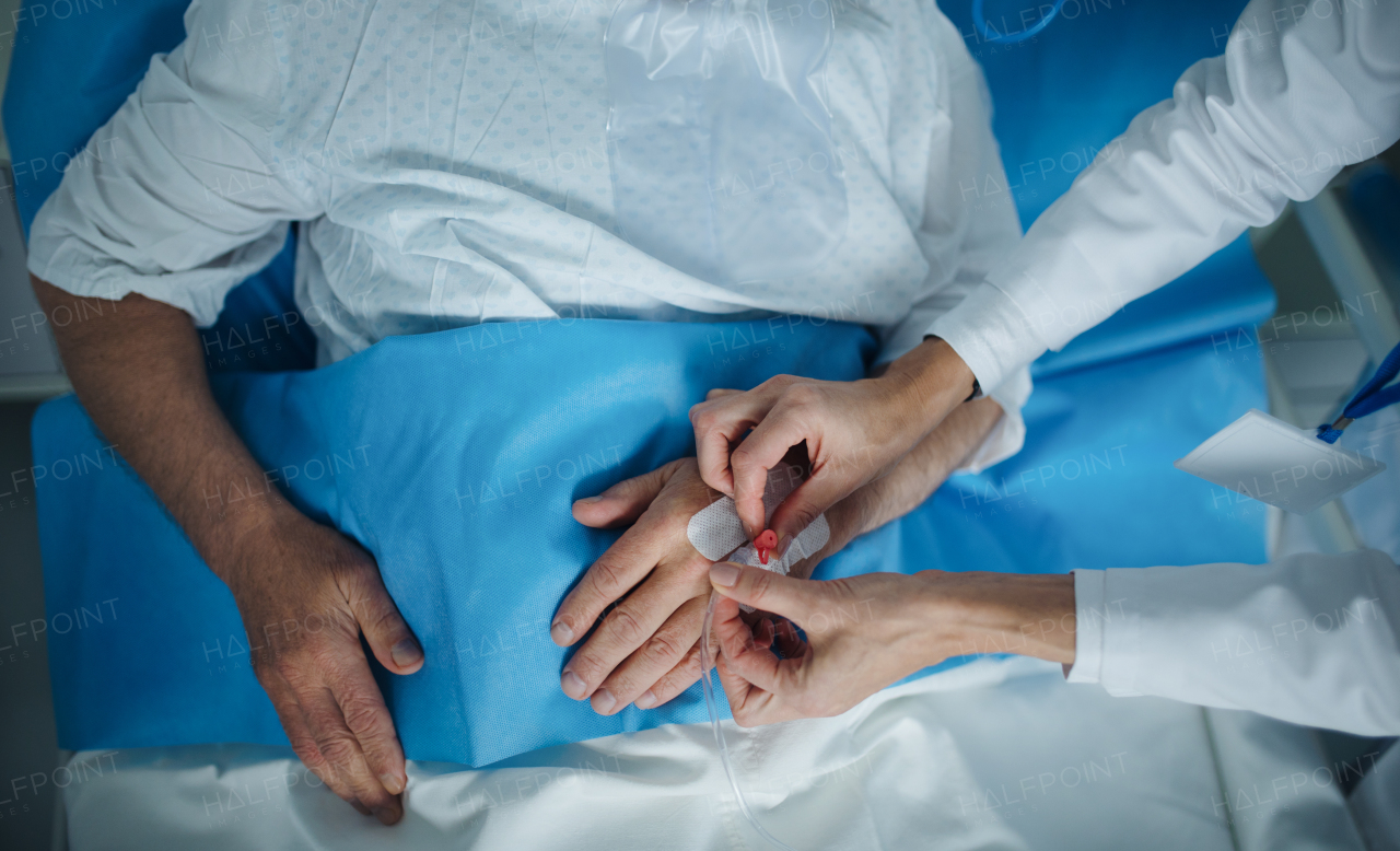 Top view of nurse applying cannula at the patients hand.