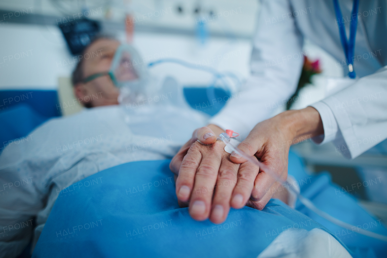 Close-up of nurse applying cannula at the patients hand.