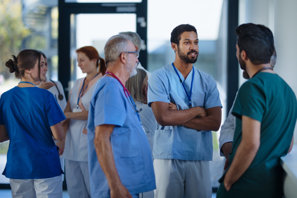 Doctors and nurses talking together at a hospital corridor.