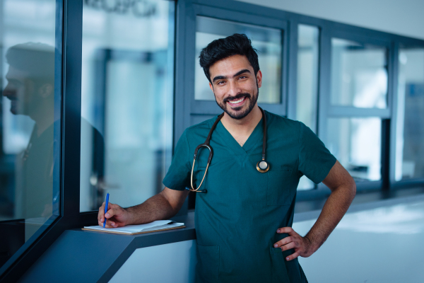 Portrait of happy young doctor at a hospital room.