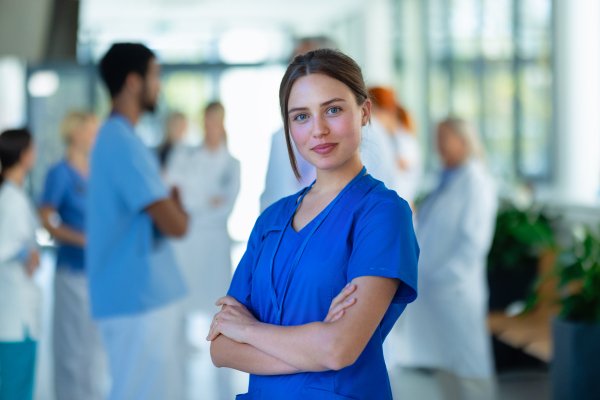 Portrait of young woman doctor at a hospital corridor.