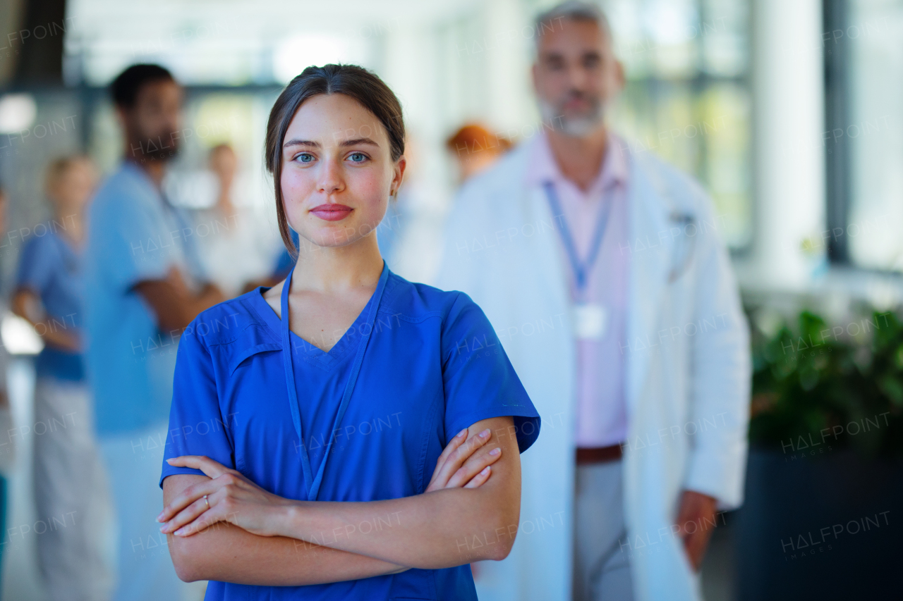 Portrait of young woman doctor at a hospital corridor.