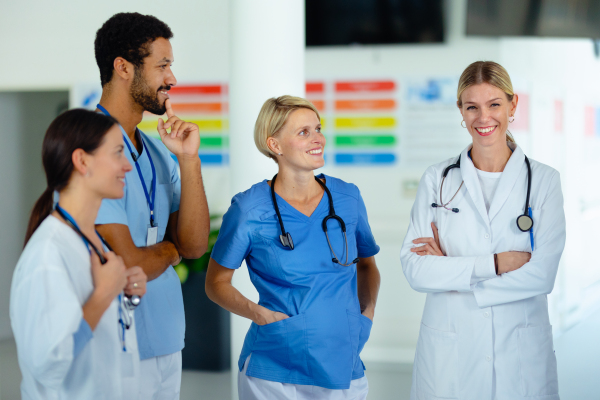 Team of doctors discussing something at a hospital corridor.