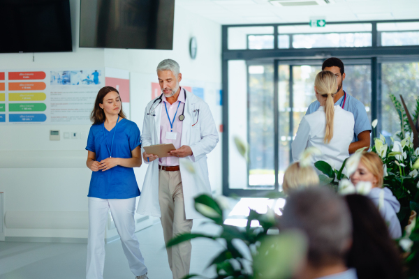 Team of doctors discussing something at a hospital corridor.