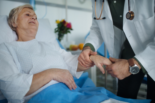 Young doctor checking blood presure to senior patient.