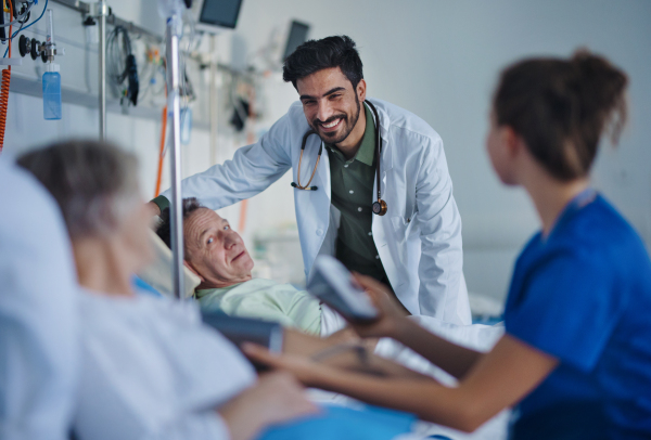 Young middle eastern doctor smiling during examining patients in a hospital room.