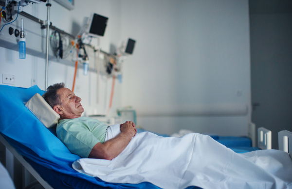 Senior man lying in the hospital bed.