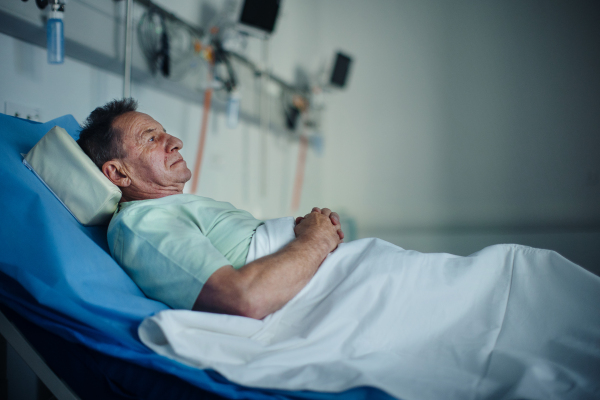 Senior man lying in the hospital bed.