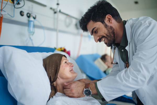 Young middle eastern doctor smiling during examining patients in a hospital room.